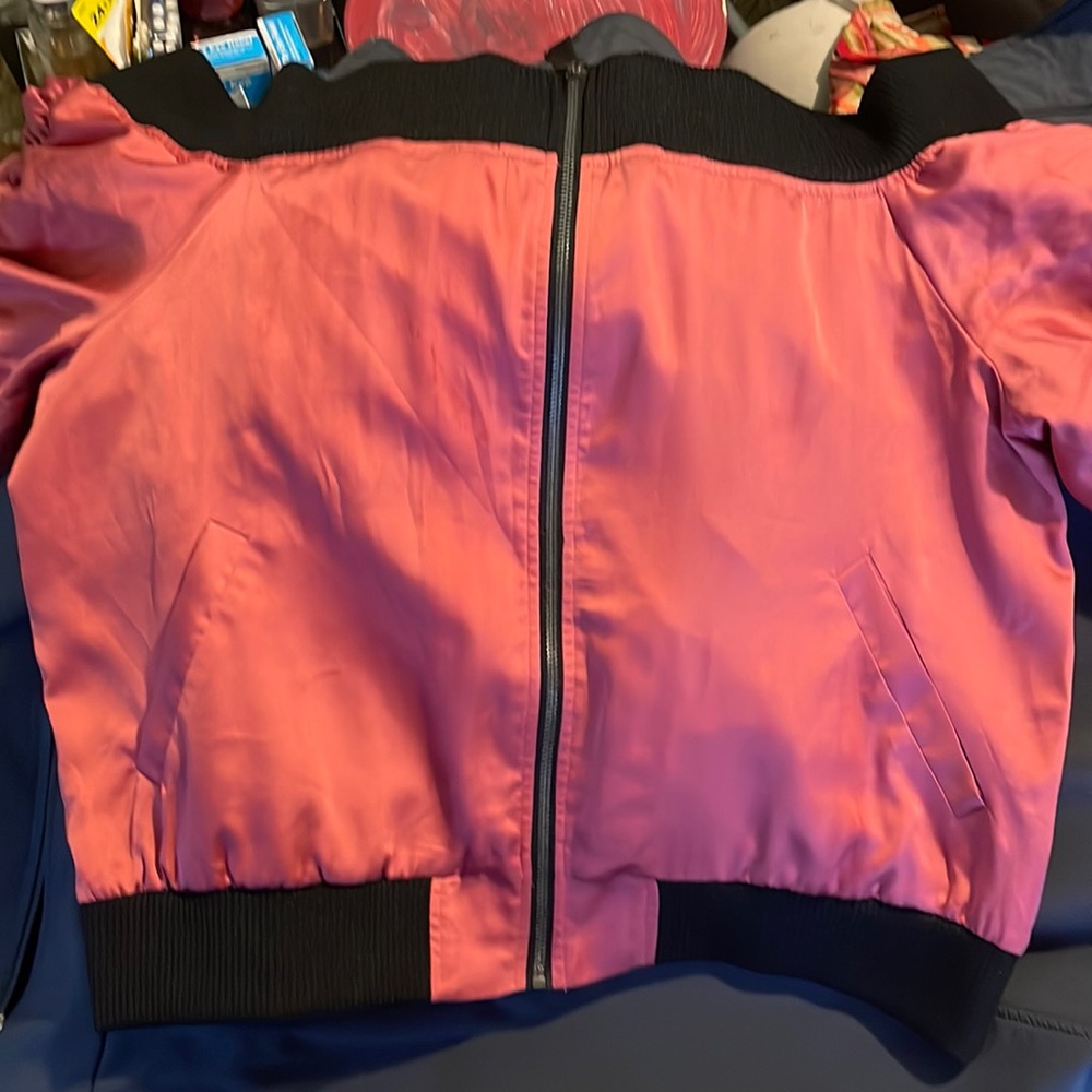Project Runway, off the shoulder pink jacket.